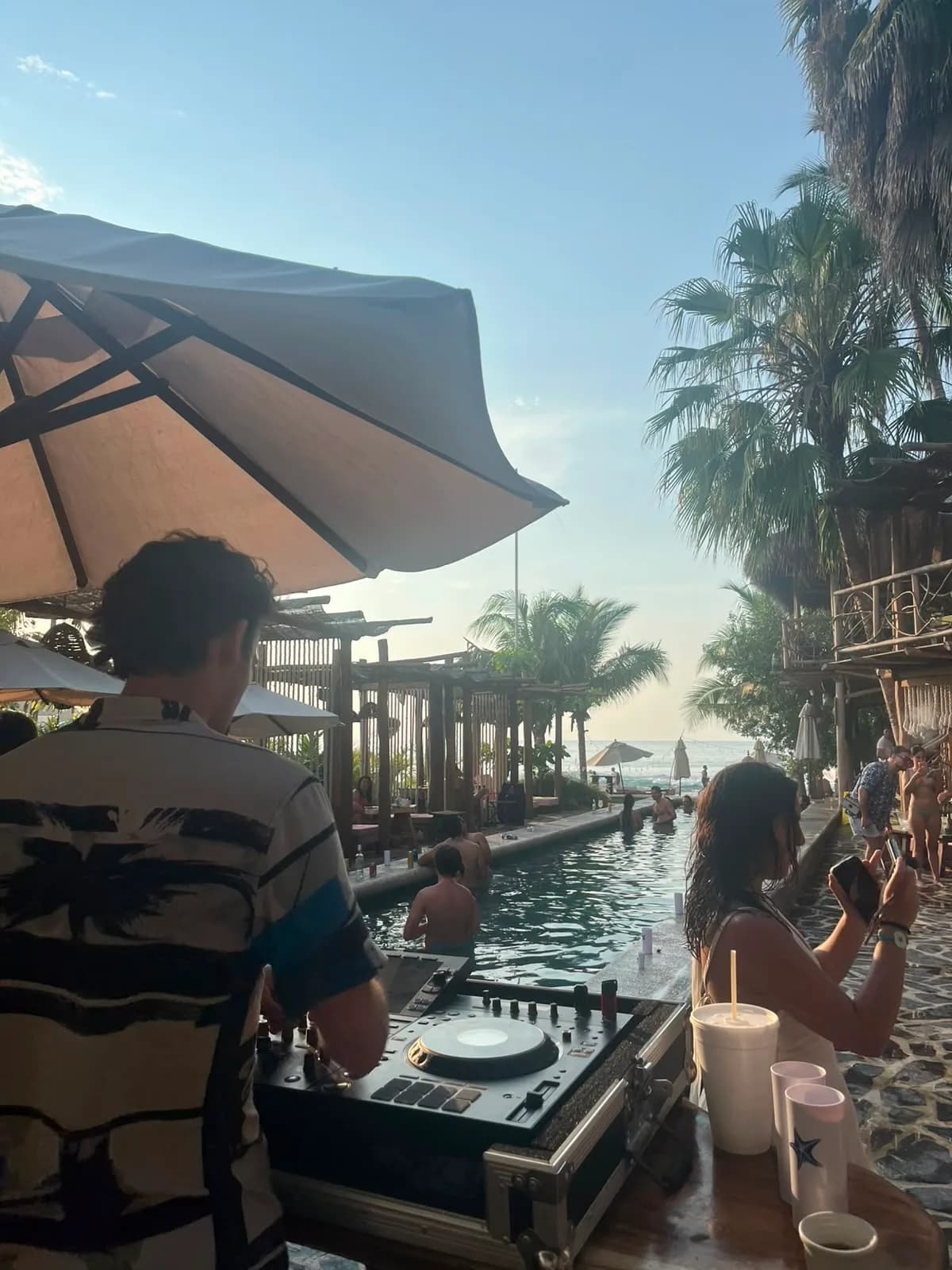 Playing to the pool as the sun drops toward the sea